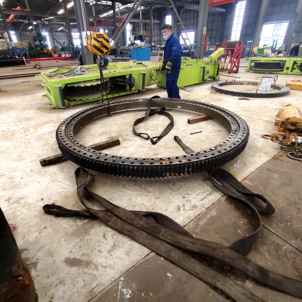 Damaged custom slewing bearing removed from a truck crane for inspection and replacement